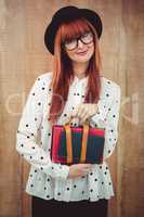 Smiling hipster woman holding book belt