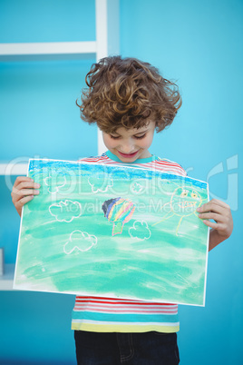 Smiling boy holding a picture