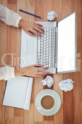 Cropped image of woman using laptop