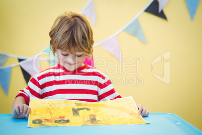 Smiling child holding his finished painting