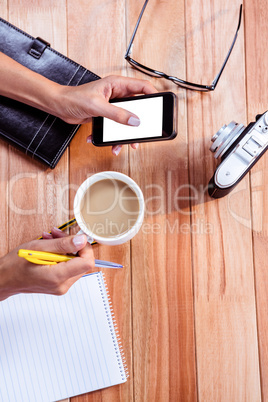 Part of hands typing on smartphone