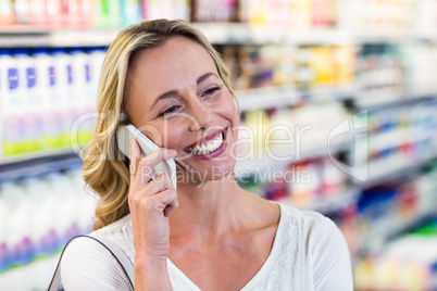 Smiling blonde woman having a call phone