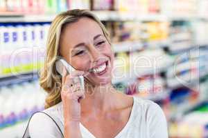 Smiling blonde woman having a call phone