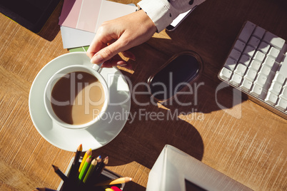 Cropped image of woman holding coffee cup