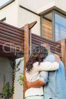 Couple with arms above after buying house