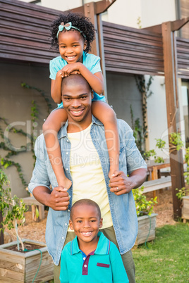 Happy father and children in the garden