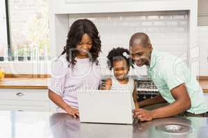 Happy family using laptop