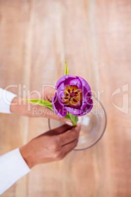 Woman putting a flower in a vase