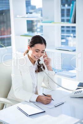 Smiling businesswoman using her telephone