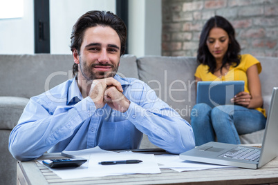 Handsome man in living room smiling at the camera