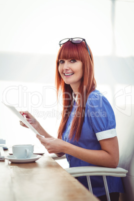 Smiling hipster woman with document