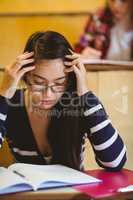 Thoughtful student studying on notebook