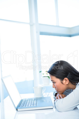 Worried businesswoman in front of her laptop