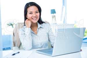 Smiling businesswoman at the desk