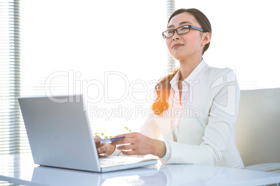 Smart businesswoman using her laptop