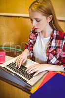 Focused student using laptop during class