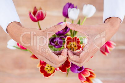 View of hands making heart shape