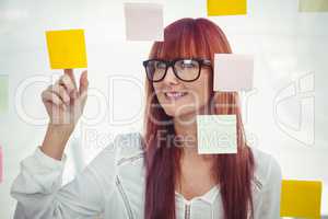 Attractive hipster woman pointing sticky notes