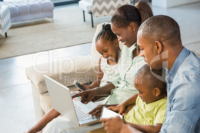 Happy family using technology together