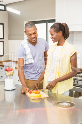 Young casual couple making fruits