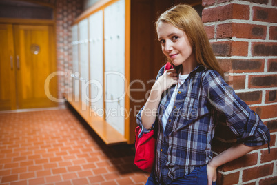 Pretty student leaning against the wall