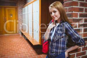 Pretty student leaning against the wall
