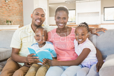 Happy family reading a book together