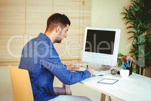 Handsome hipster working at desk