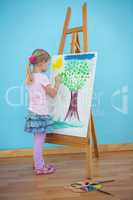 Girl painting her colourful picture