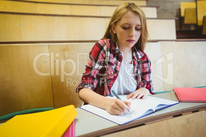Focused student taking notes during class