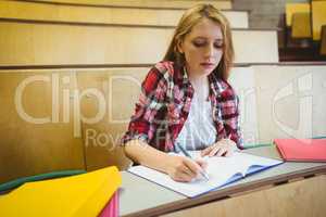 Focused student taking notes during class