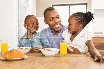 Casual happy family having breakfast