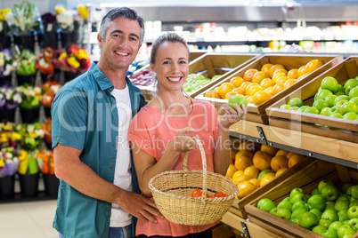 Happy couple holding an apple