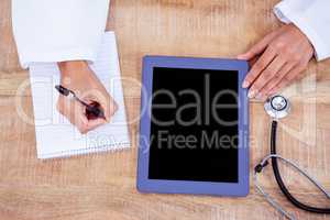 Doctor writing on a notepad