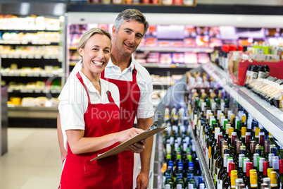 Smiling colleagues with clipboard