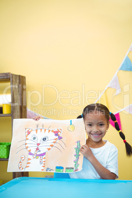Smiling girl with a painting of her cat