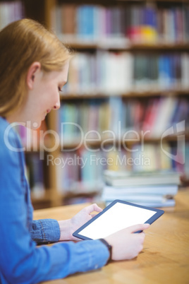 Student with smartwatch using tablet in library