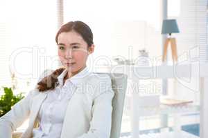 Thoughtful businesswoman sitting on a chair