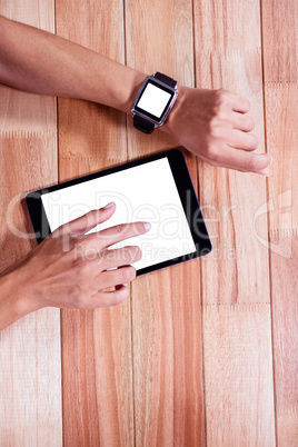 Feminine hands with smartwatch using tablet