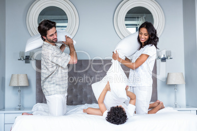 Happy family pillow fighting