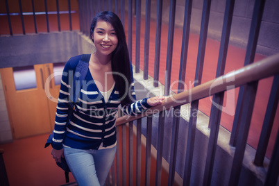 Smiling student walking up steps