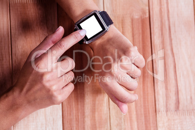 Part of hands typing on a watch