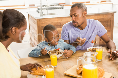 Casual happy family having breakfast