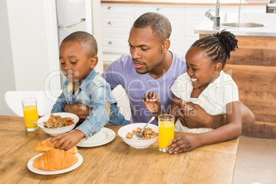 Casual happy family having breakfast