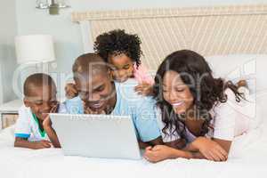 Family having fun together in bed