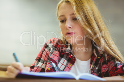 Focused student taking notes during class