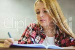 Focused student taking notes during class