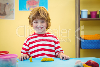 Happy boy with modelling clay