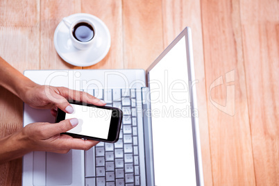 Overhead of feminine hands using smartphone