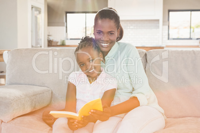 Loving mother with daughter on the couch